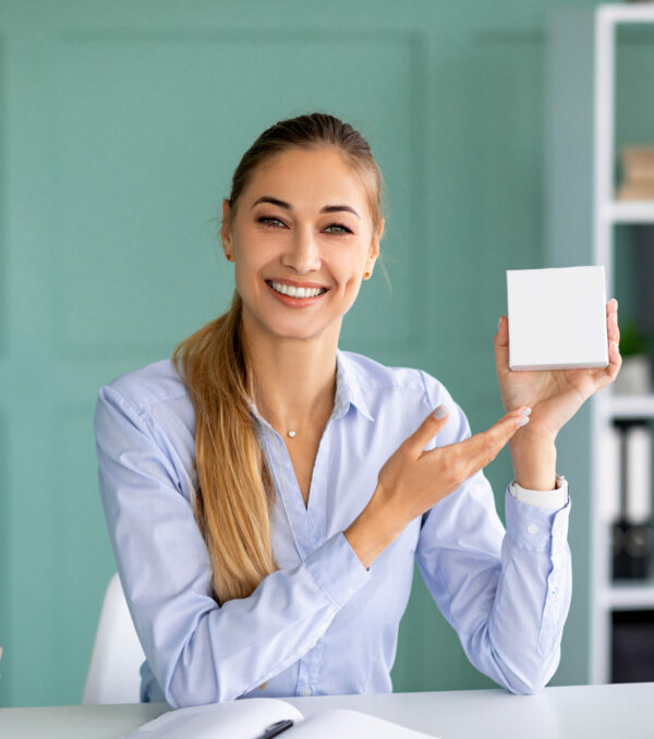Female blogger recording review video of product in box with copy space, mockup for your design Female blogger recording review video of product in box with copy space, mockup for your design. Showing purchases ordered on Internet, blog content, feedback