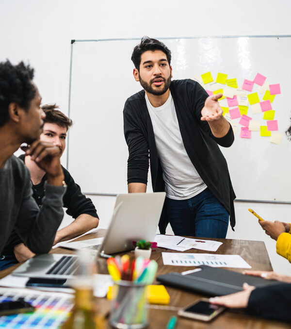 Manager leading a brainstorming meeting. Manager leading a brainstorming meeting with a group of creative designers in the office. Leader and business concept