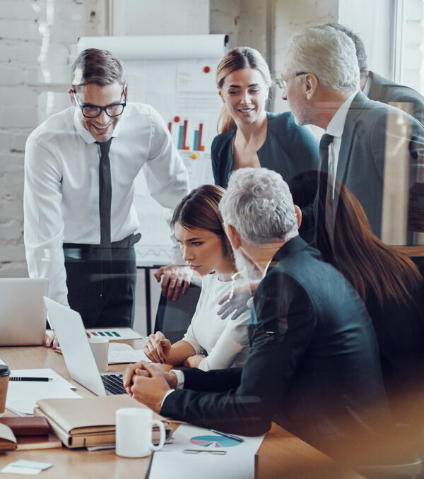 Successful business team analyzing sales while having staff meet Successful business team analyzing sales while having staff meeting in the board room