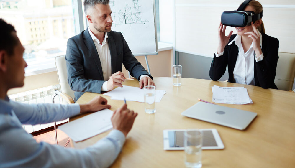 Group of modern managers testing new technological gadget